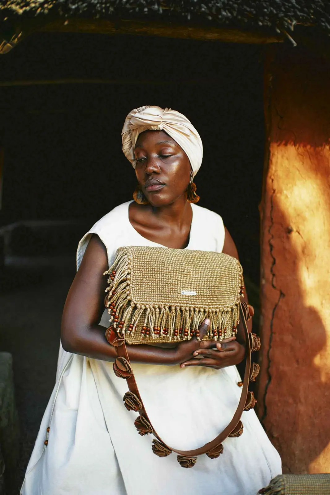 Model holding the Beaded Fringe Nhava shoulder bag