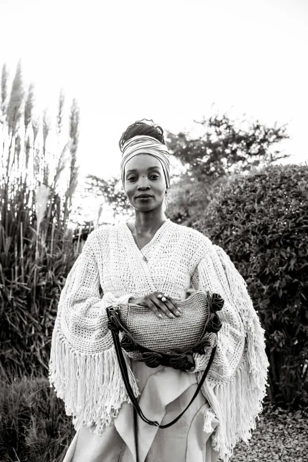 Chido Kaseke holding a handcrafted PatCh handbag